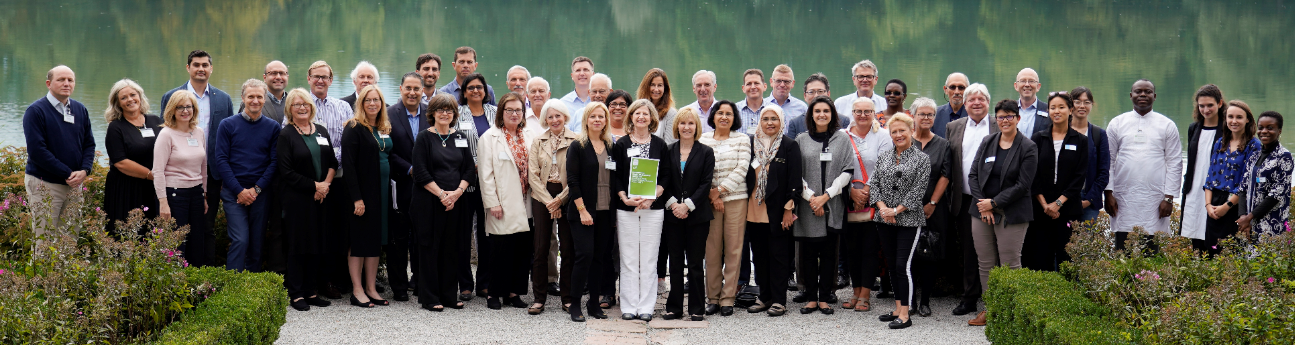 Attendees of the Salzburg Global Forum standing in front of a lake.