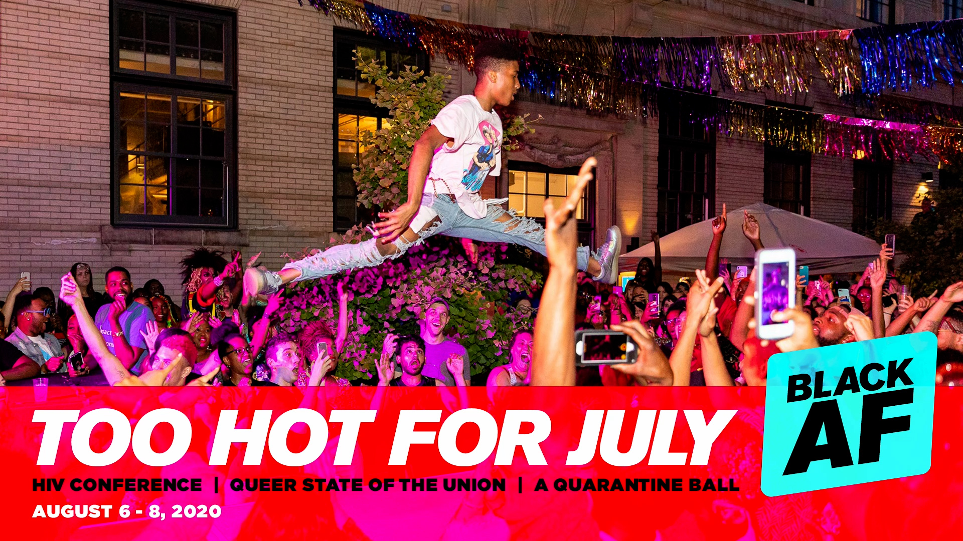 Participants of Too Hot for July in a previous year enjoy festivities and music. A crowd gathers raising phones in the air while a young man leaps over them.