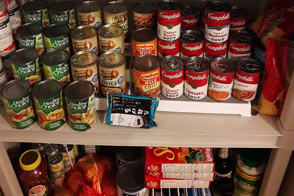 Canned food and groceries on shelves.
